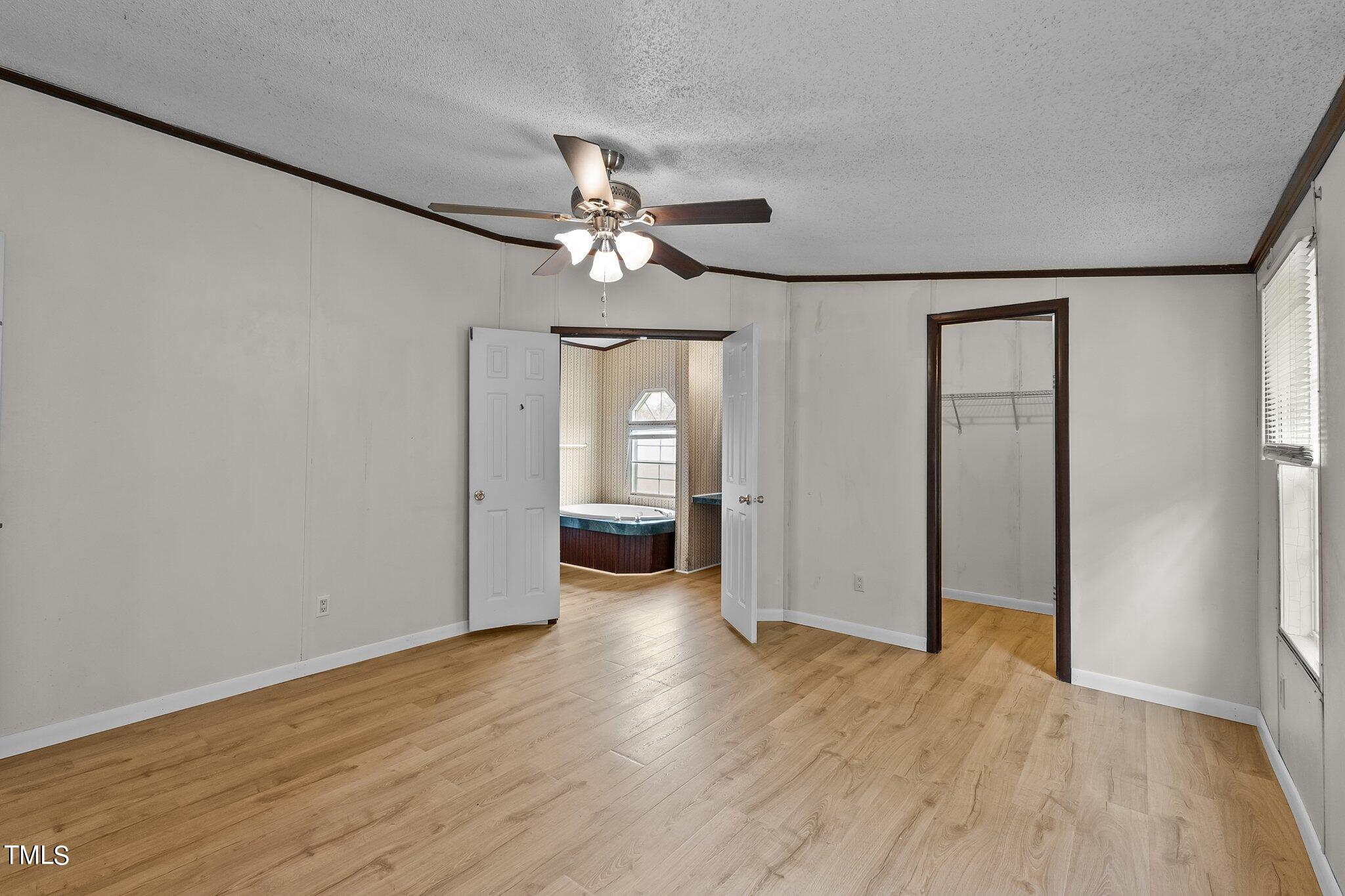 5612 Zacks Mill Road Angier, NC 27501 - Photo 18 of 42 wooden floor in an empty room with a window
