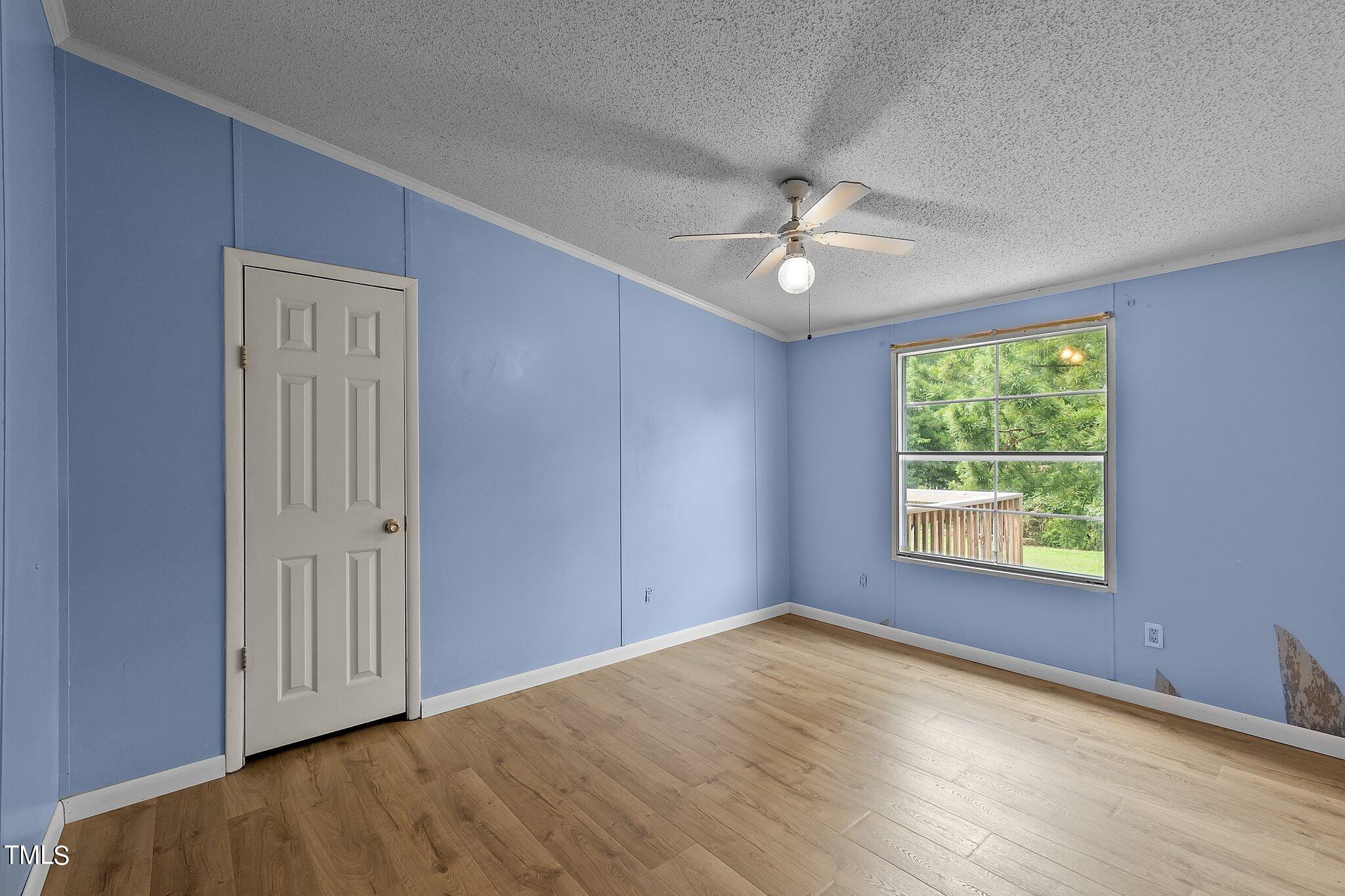 5612 Zacks Mill Road Angier, NC 27501 - Photo 24 of 42 an empty room with a window and ceiling fan
