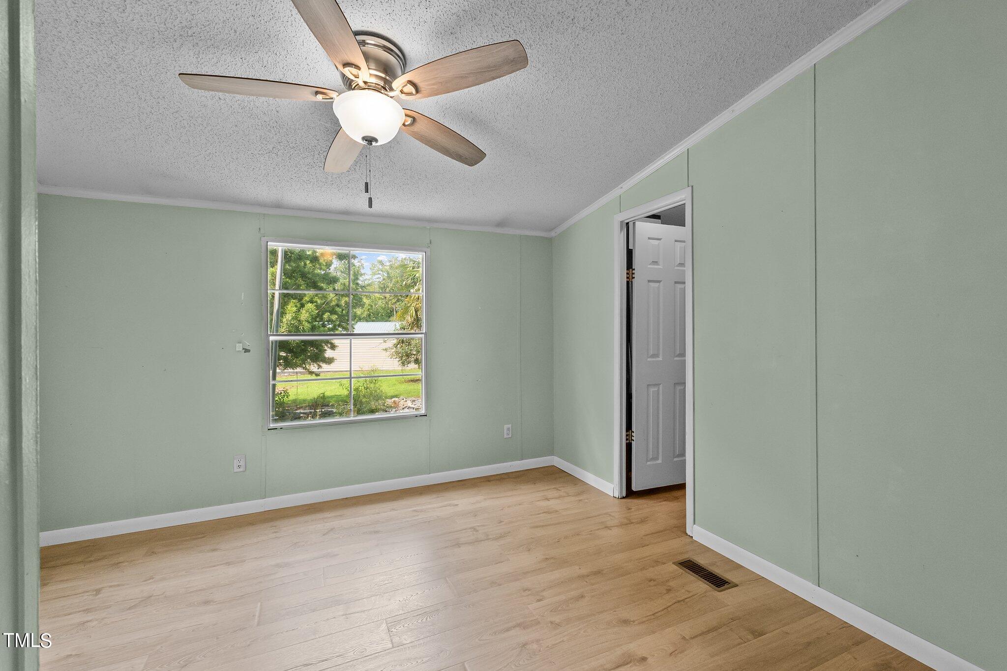 5612 Zacks Mill Road Angier, NC 27501 - Photo 26 of 42 an empty room with windows and fan