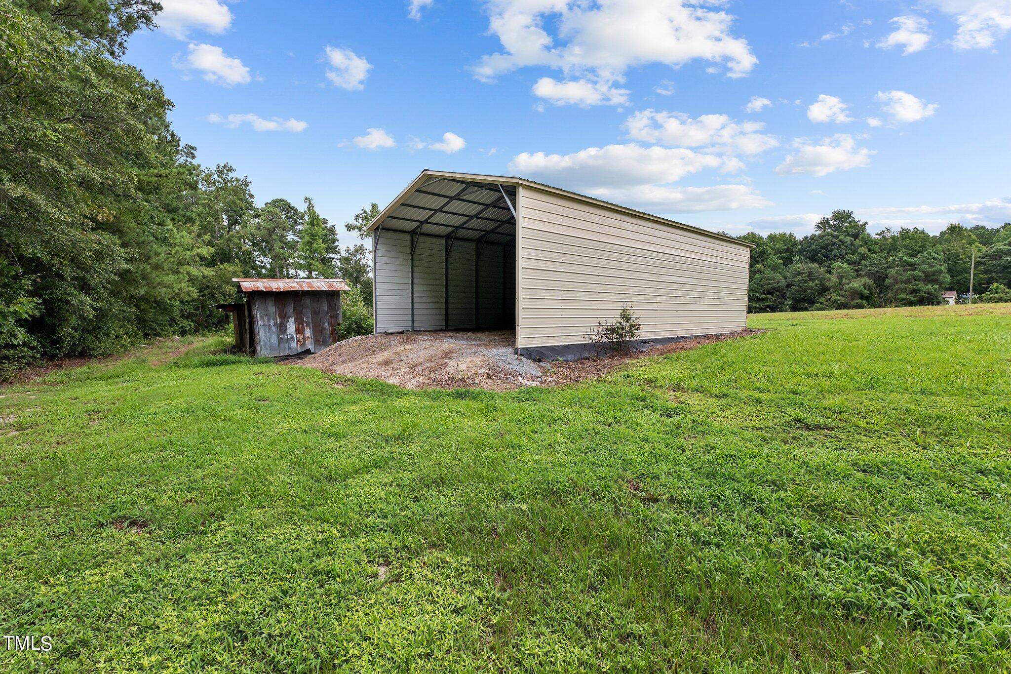 5612 Zacks Mill Road Angier, NC 27501 - Photo 3 of 42 a view of a backyard with a garden