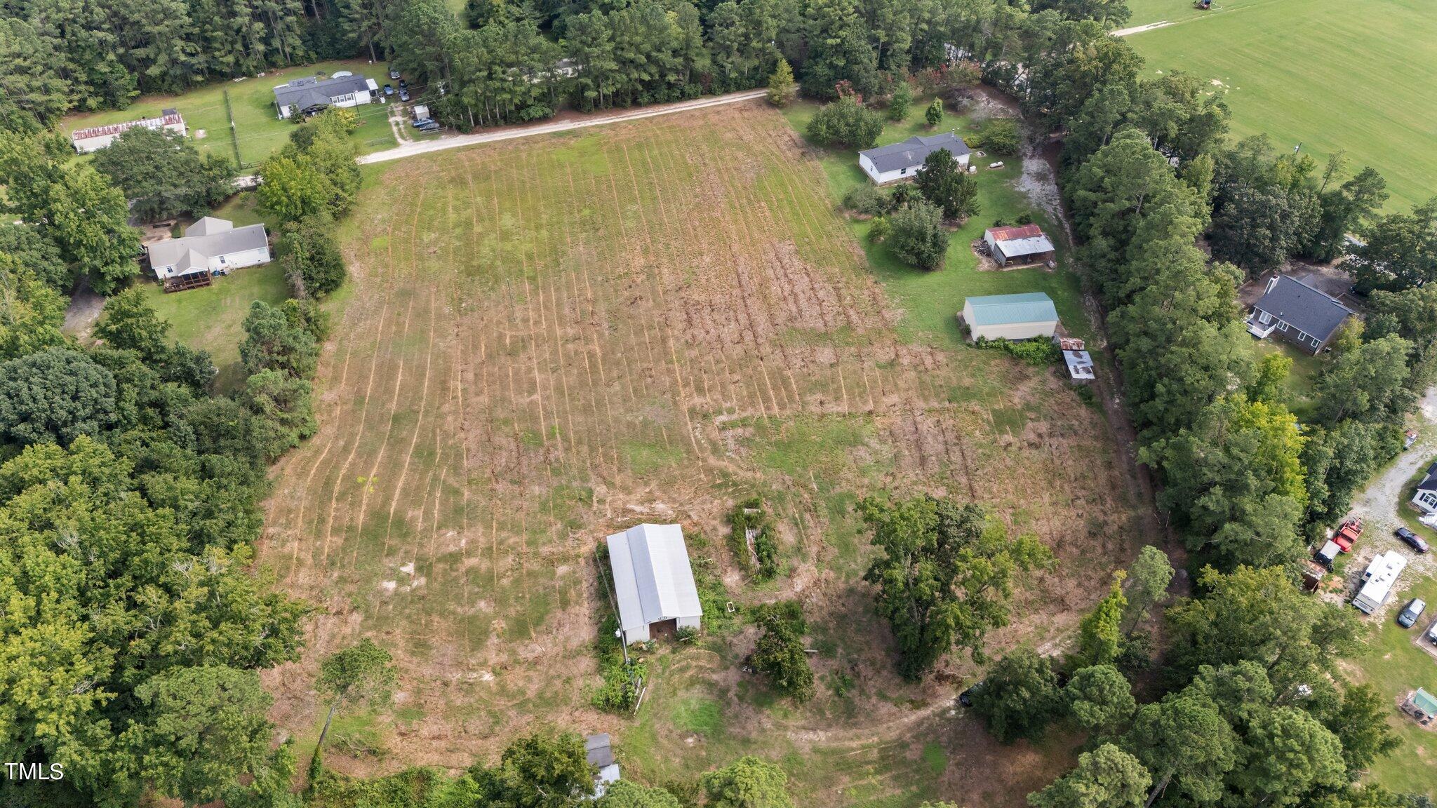 5612 Zacks Mill Road Angier, NC 27501 - Photo 38 of 42 an aerial view of a residential house with an outdoor space and seating area