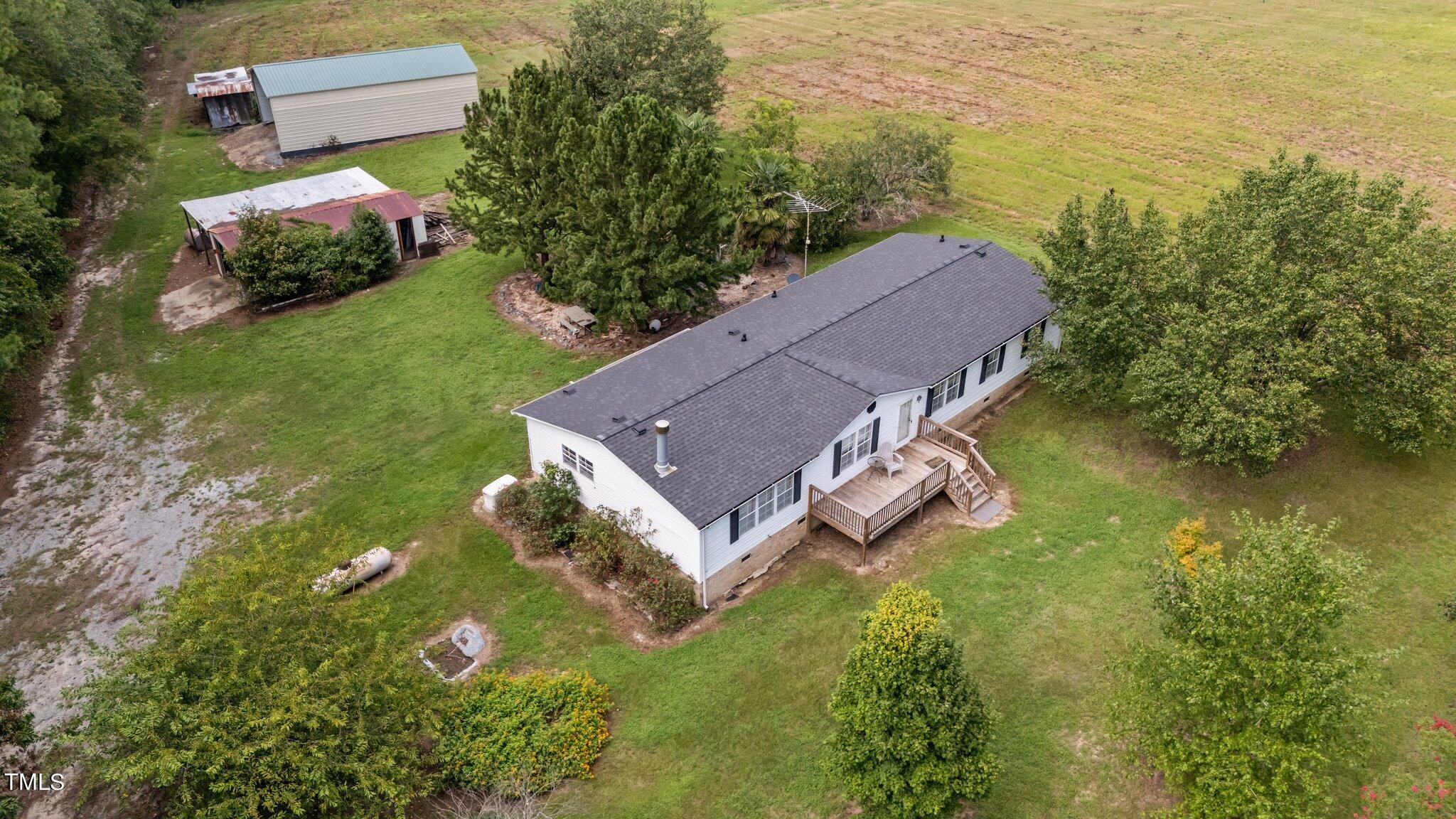 5612 Zacks Mill Road Angier, NC 27501 - Photo 40 of 42 an aerial view of a house with a garden and swimming pool