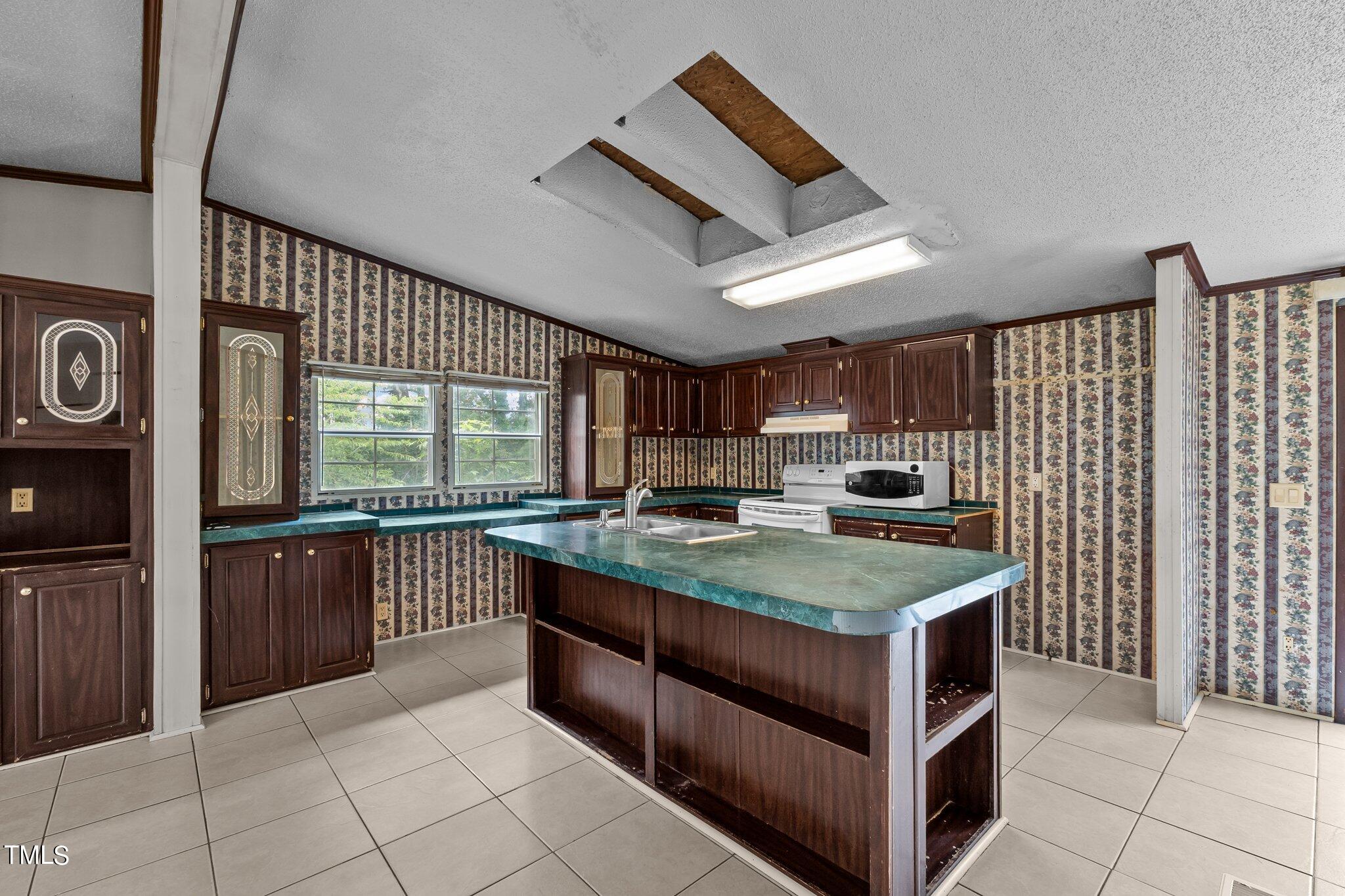 5612 Zacks Mill Road Angier, NC 27501 - Photo 10 of 42 a kitchen with stainless steel appliances granite countertop a sink and cabinets