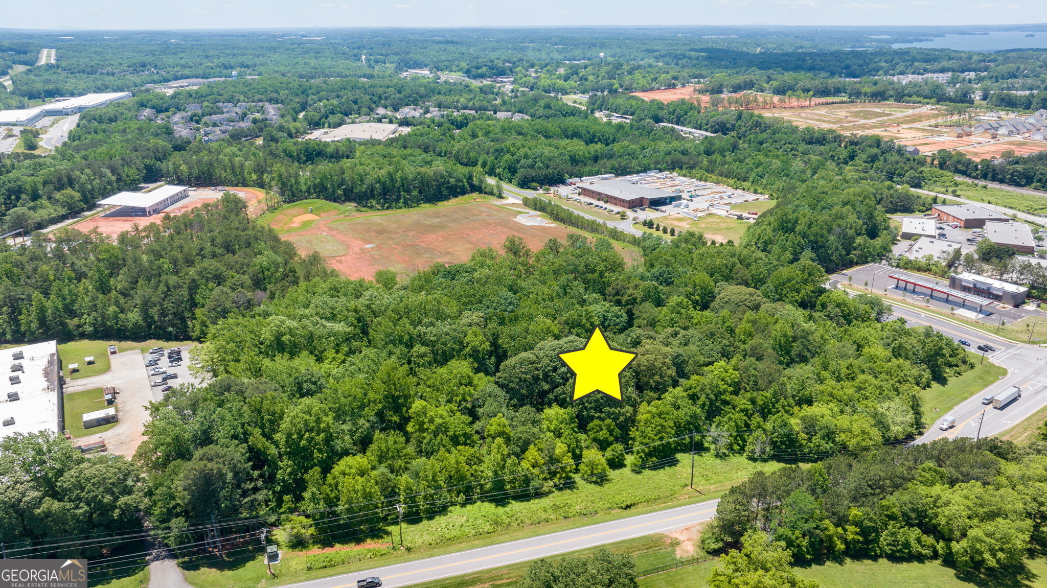 4611 Thurmon Tanner Road Flowery Branch, GA 30542 - Photo 13 of 23 an aerial view of a house with a garden and mountain view