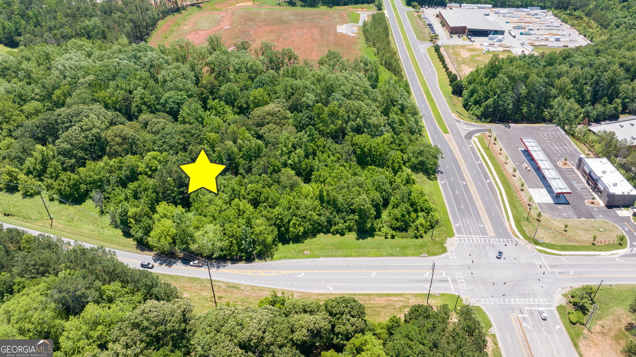 4611 Thurmon Tanner Road Flowery Branch, GA 30542 - Photo 4 of 23 an aerial view of a house with a garden and swimming pool