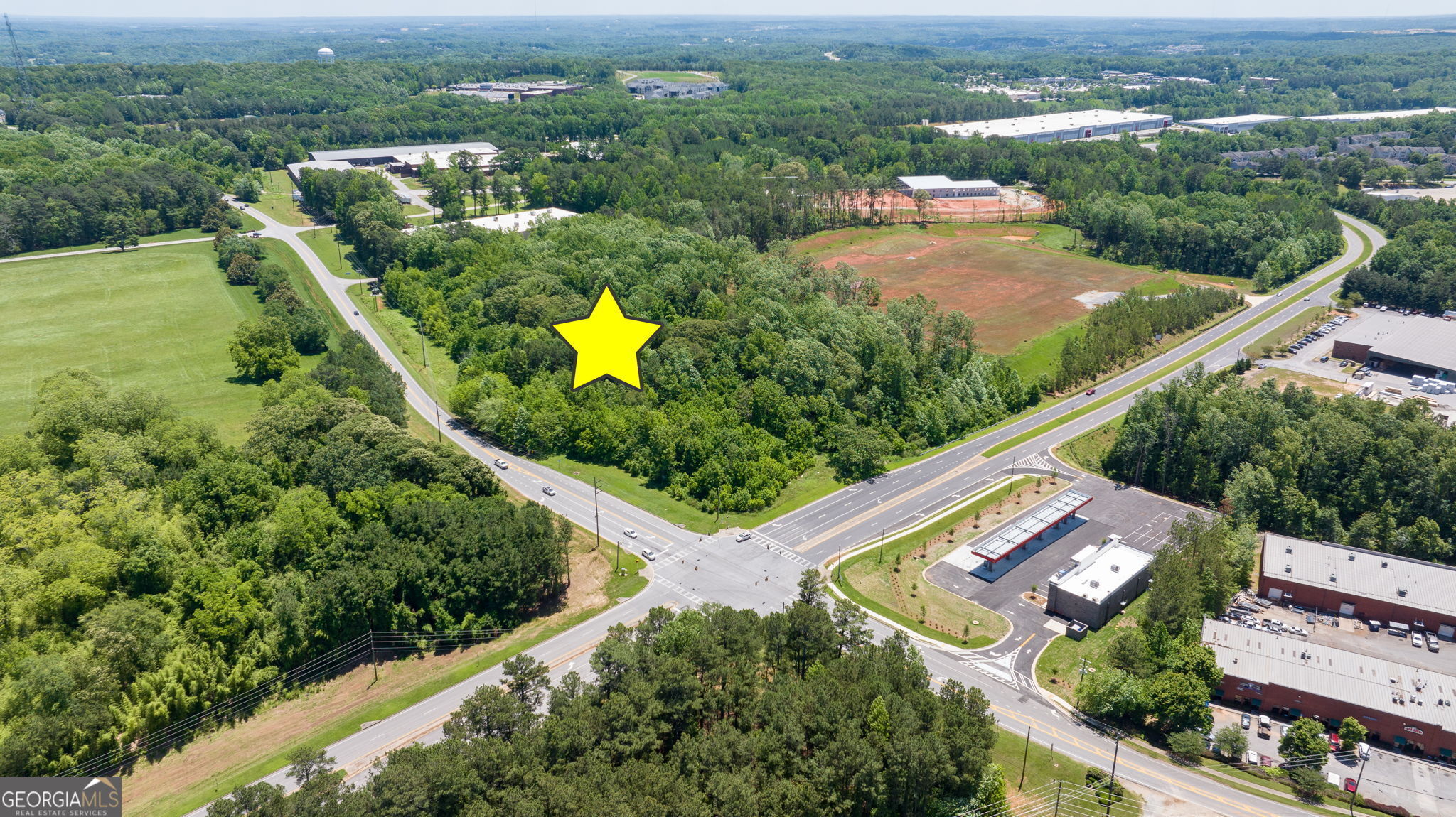 4611 Thurmon Tanner Road Flowery Branch, GA 30542 - Photo 6 of 23 an aerial view of a house with a garden