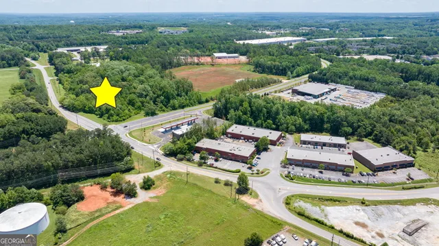 an aerial view of a house with a garden and lake view