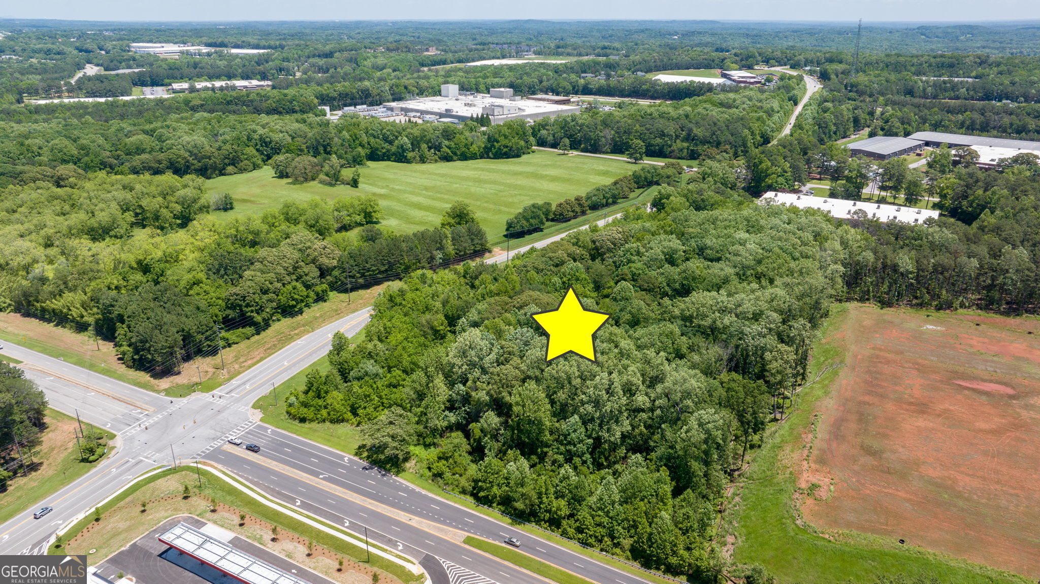 4611 Thurmon Tanner Road Flowery Branch, GA 30542 - Photo 8 of 23 an aerial view of a house with a garden and lake view
