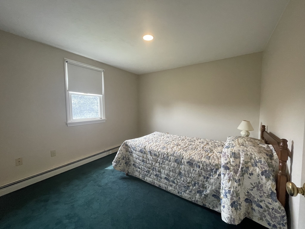 20 Studley Street Fairhaven, MA 02719 - Photo 12 of 16 a bed sitting in a bedroom next to a window