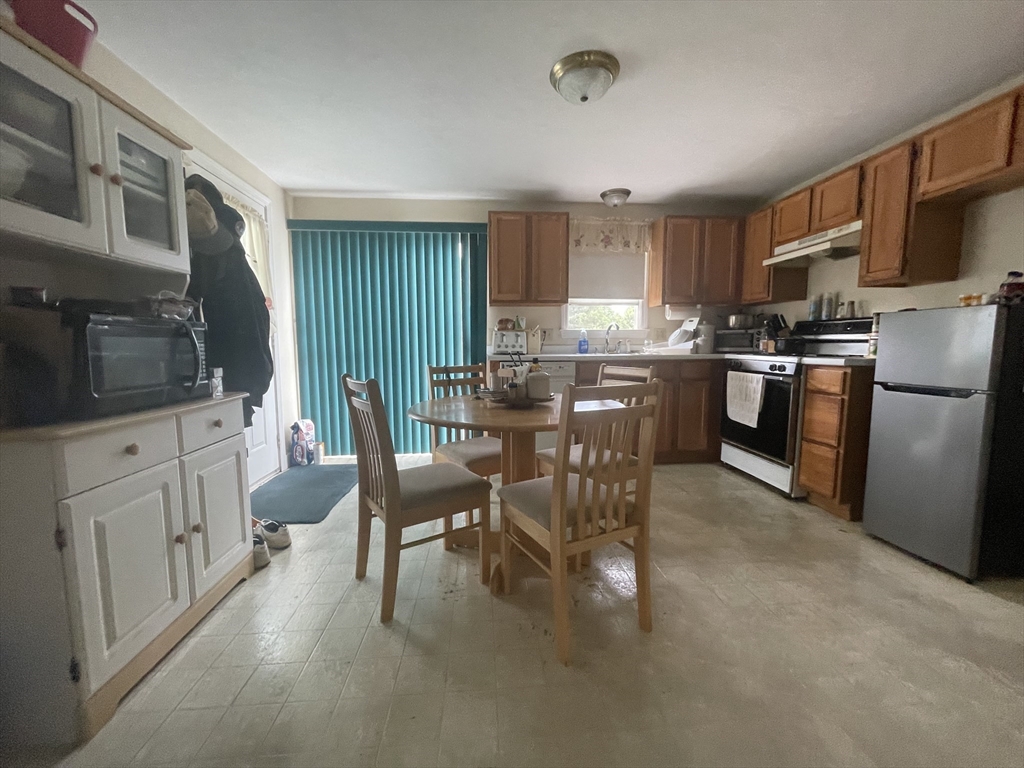 20 Studley Street Fairhaven, MA 02719 - Photo 4 of 16 a kitchen with stainless steel appliances kitchen island granite countertop a stove top oven a sink a dining table and chairs