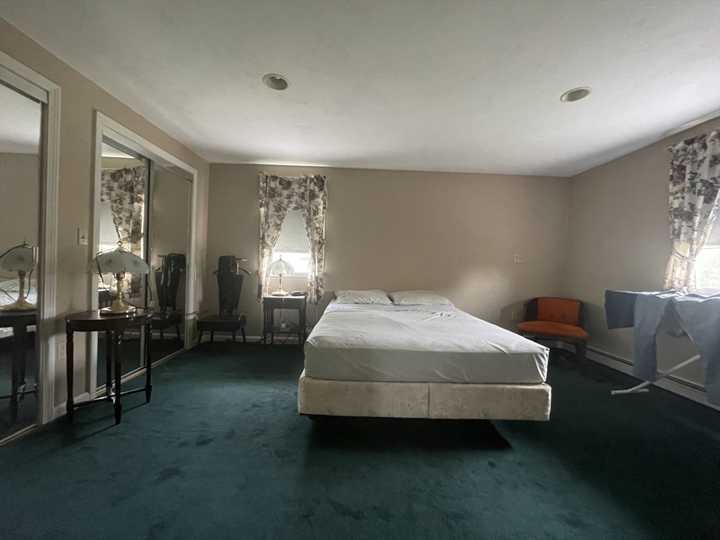 20 Studley Street Fairhaven, MA 02719 - Photo 10 of 16 a spacious bedroom with a bed and large windows