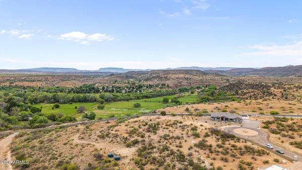 a view of a lush green hillside and houses