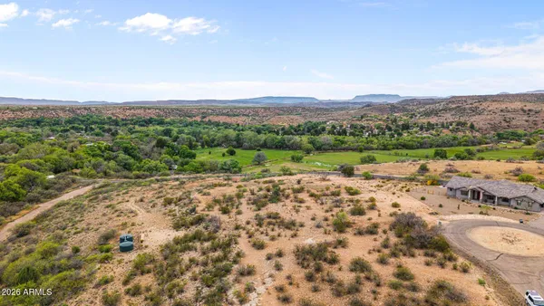 a view of a big yard with lots of green space