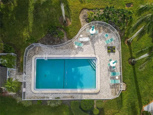 an aerial view of a house with outdoor space pool seating area and yard