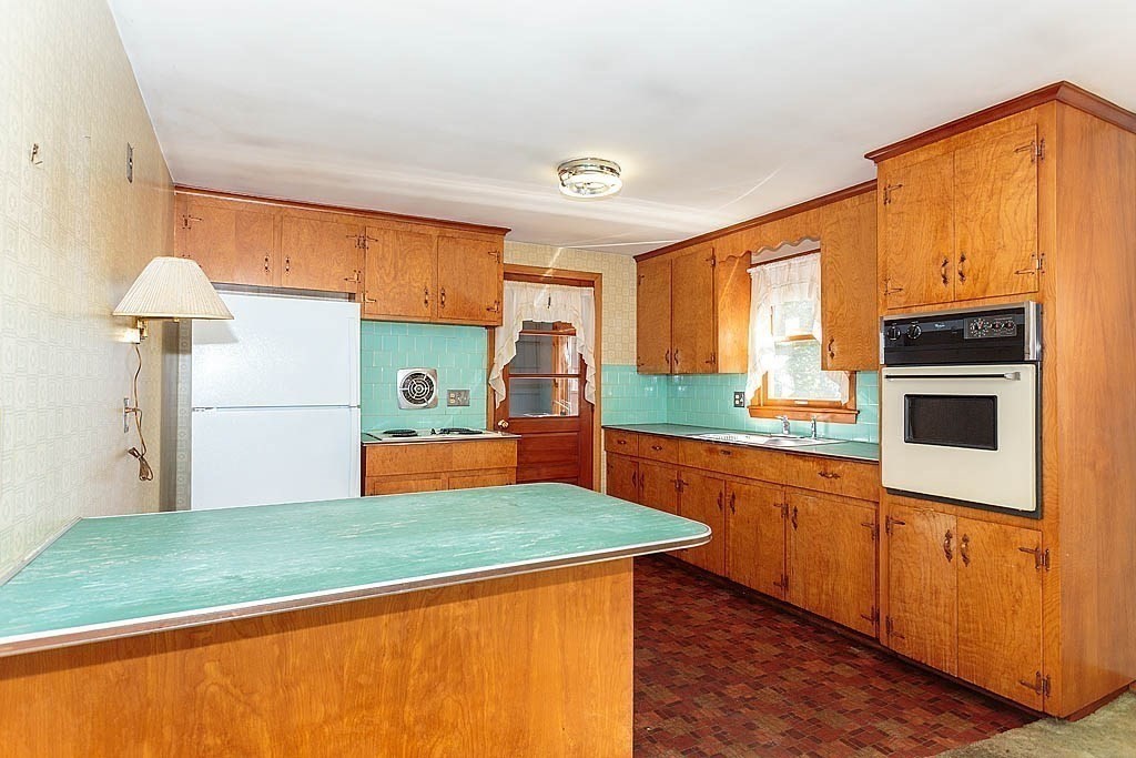 74 Summer Hill Road Maynard, MA 01754 - Photo 3 of 27 a kitchen with stainless steel appliances granite countertop a sink and a refrigerator