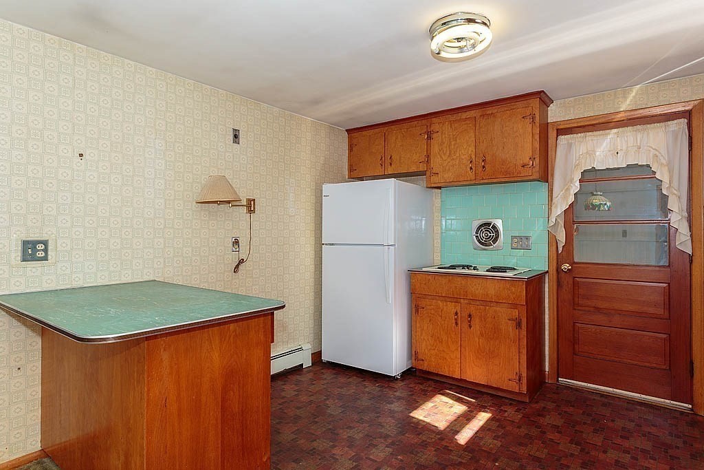 74 Summer Hill Road Maynard, MA 01754 - Photo 4 of 27 a kitchen with a refrigerator and a stove