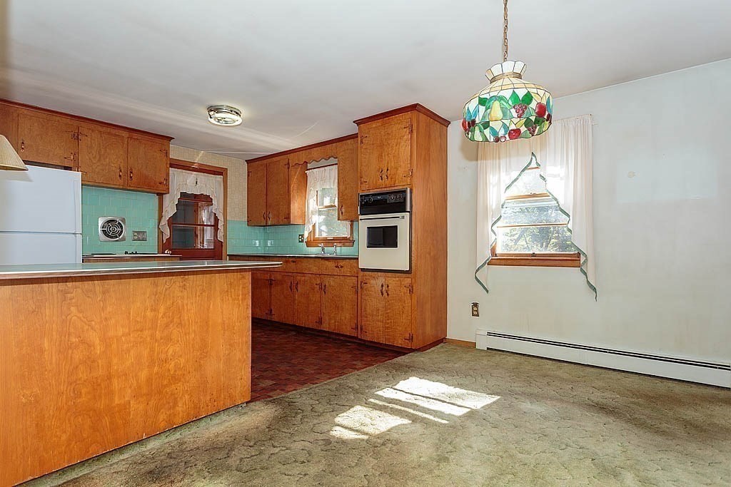 74 Summer Hill Road Maynard, MA 01754 - Photo 5 of 27 a kitchen with granite countertop a stove a sink and a refrigerator