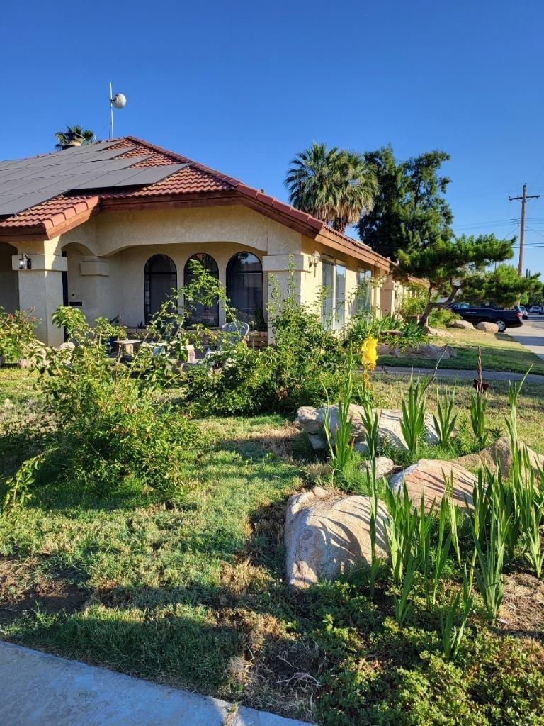 308 Monroe Street Coalinga, CA 93210 - Photo 1 of 35 a front view of a house with garden