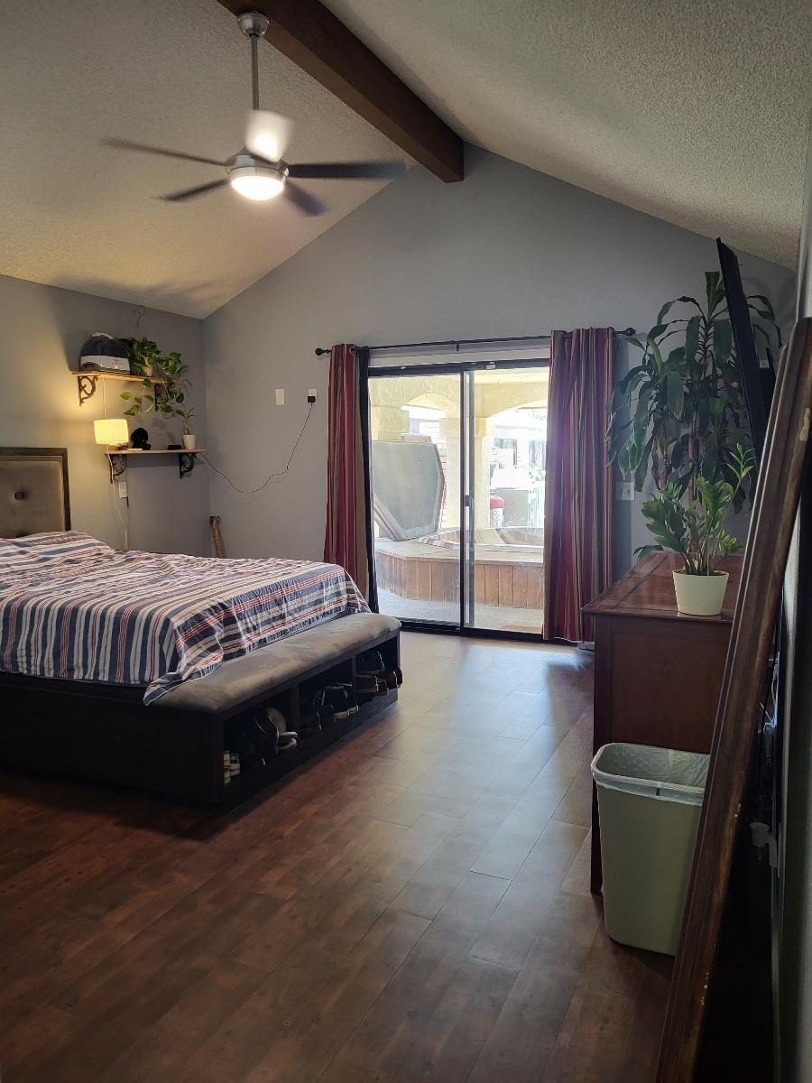 308 Monroe Street Coalinga, CA 93210 - Photo 13 of 35 a bedroom with a bed and a large window