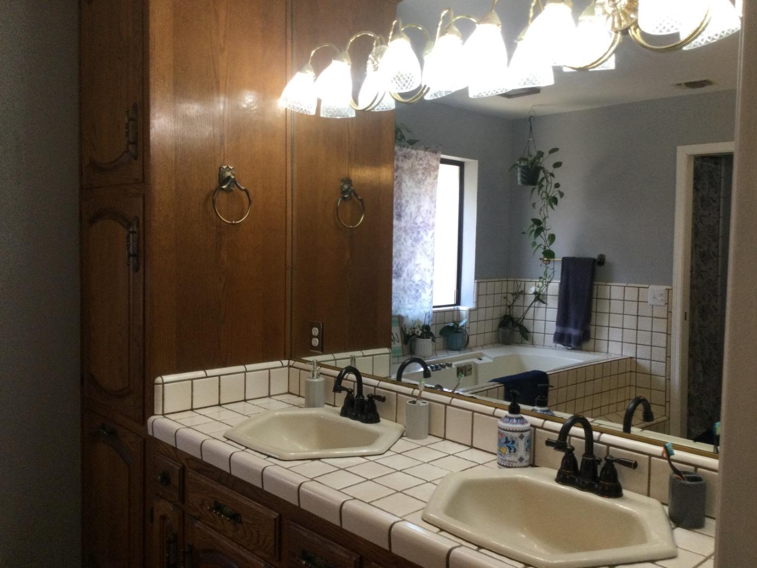 308 Monroe Street Coalinga, CA 93210 - Photo 14 of 35 a bathroom with a sink and a mirror