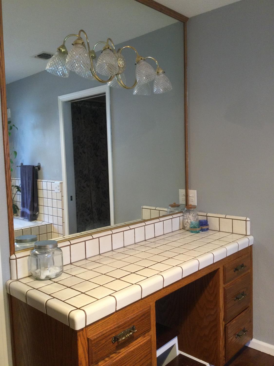 308 Monroe Street Coalinga, CA 93210 - Photo 16 of 35 a bathroom with a sink and a mirror