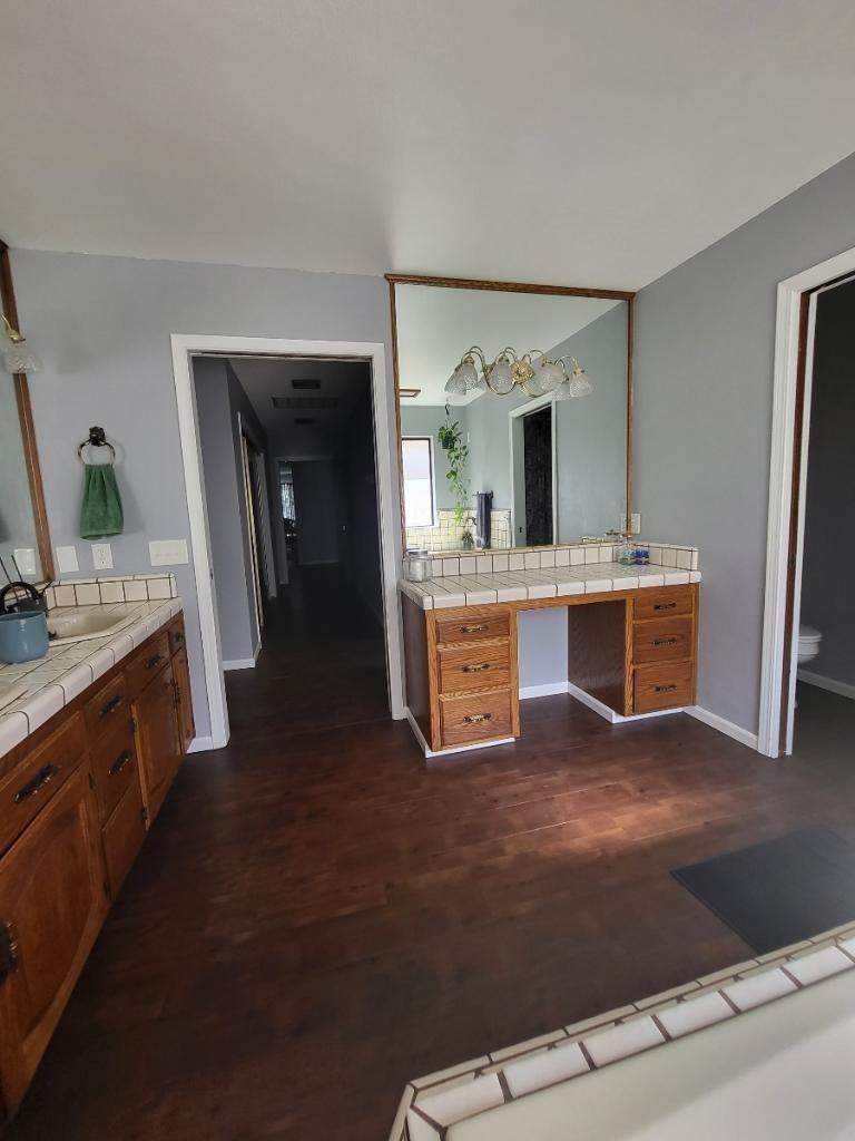 308 Monroe Street Coalinga, CA 93210 - Photo 17 of 35 a kitchen with kitchen island a sink stainless steel appliances and cabinets