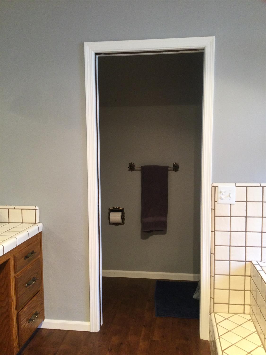 308 Monroe Street Coalinga, CA 93210 - Photo 18 of 35 a view of a hallway with wooden floor and a cabinet