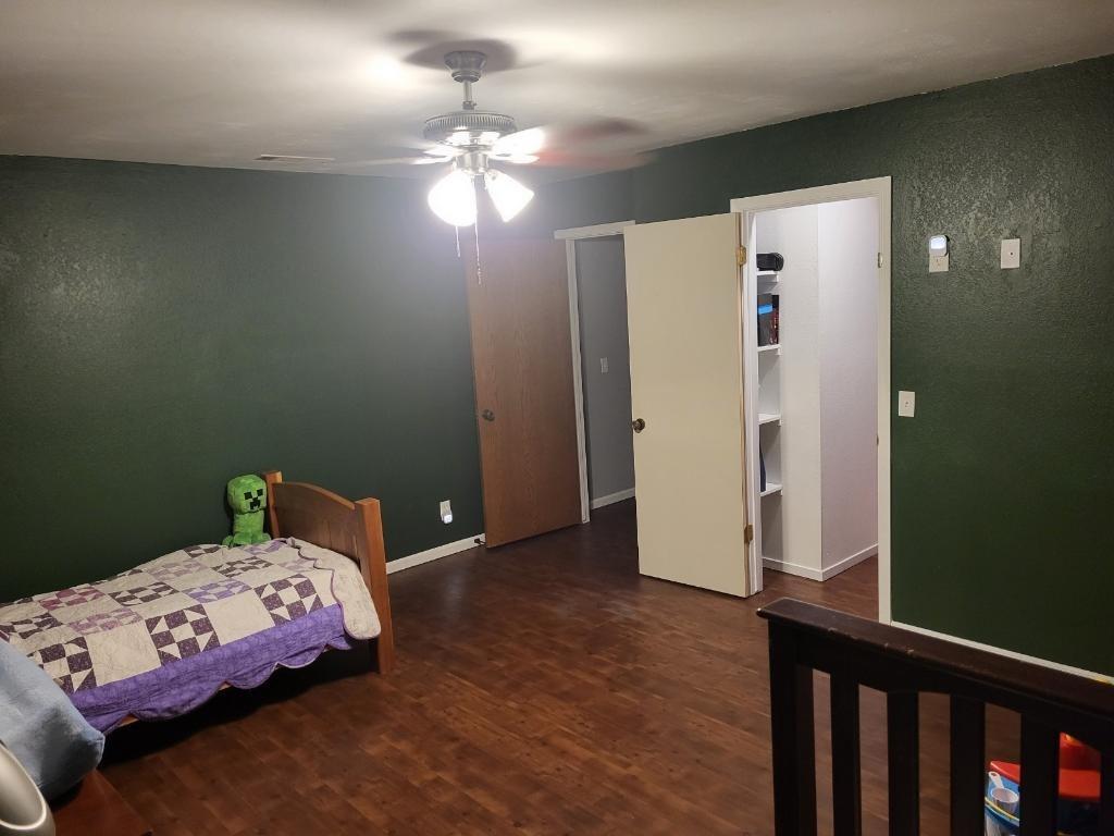 308 Monroe Street Coalinga, CA 93210 - Photo 20 of 35 a bedroom with a bed and a chandelier