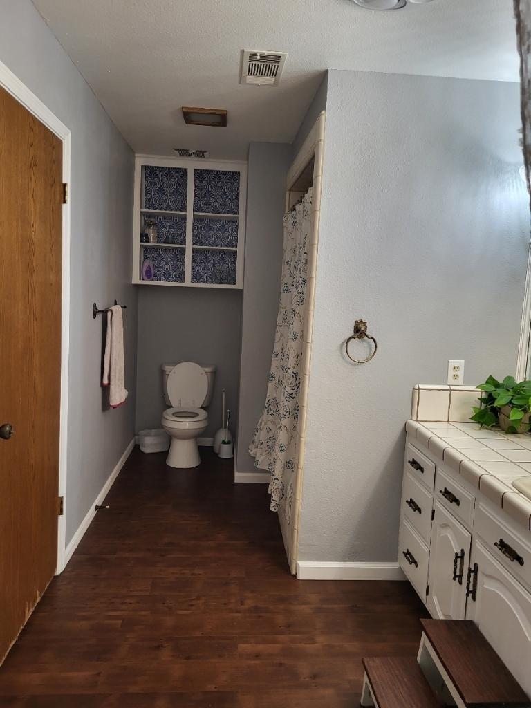 308 Monroe Street Coalinga, CA 93210 - Photo 23 of 35 a spacious bathroom with a toilet a sink and mirror