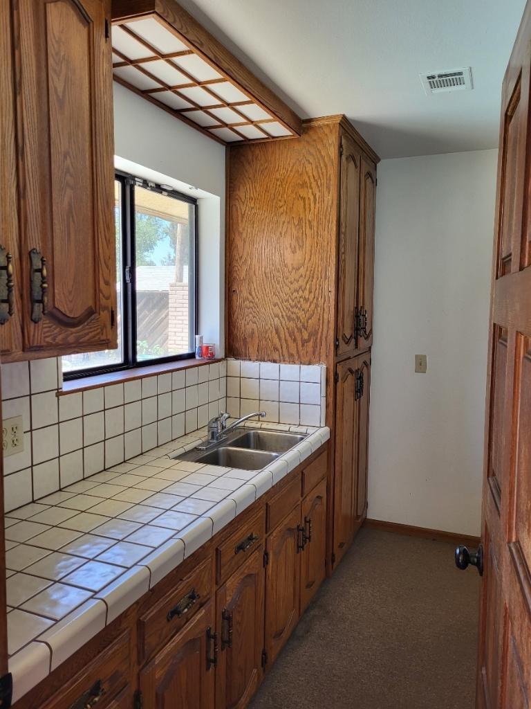 308 Monroe Street Coalinga, CA 93210 - Photo 34 of 35 a bathroom with a sink and a mirror