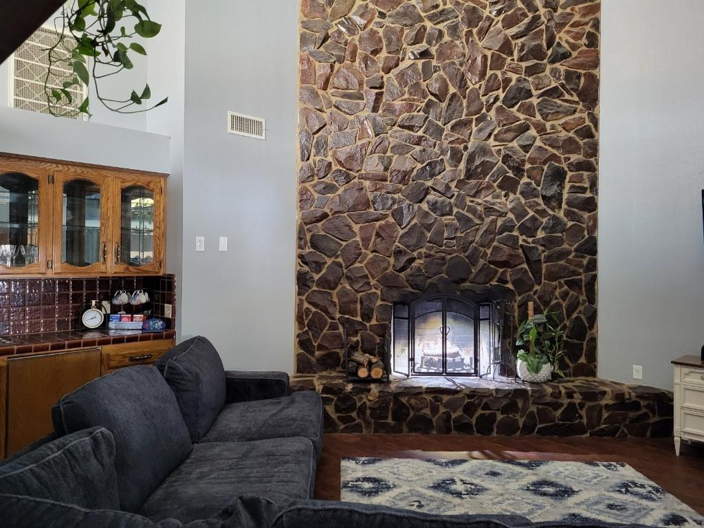 308 Monroe Street Coalinga, CA 93210 - Photo 6 of 35 a living room with furniture and a fireplace