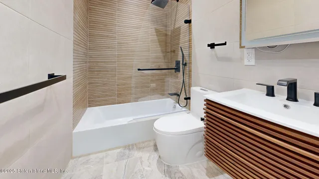 a bathroom with a sink a toilet and bathtub