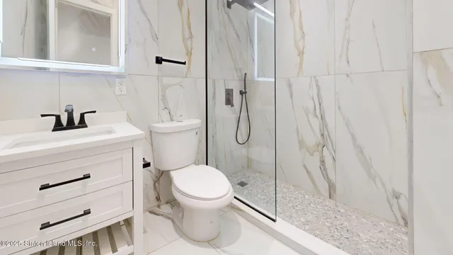 a bathroom with a toilet a sink and a shower