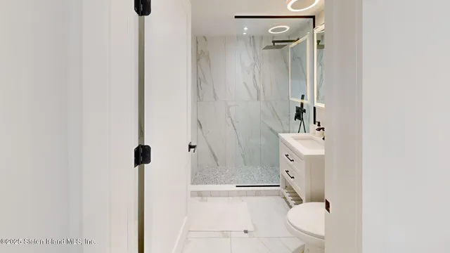 a bathroom with a toilet a sink and shower