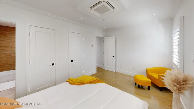 a bedroom with a bed and teddy bear on table