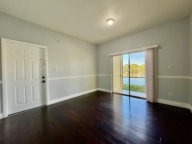 a bedroom with a large bed and a flat tv screen on dresser