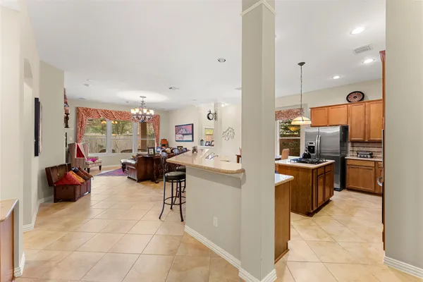 a kitchen with stainless steel appliances kitchen island granite countertop a sink and cabinets