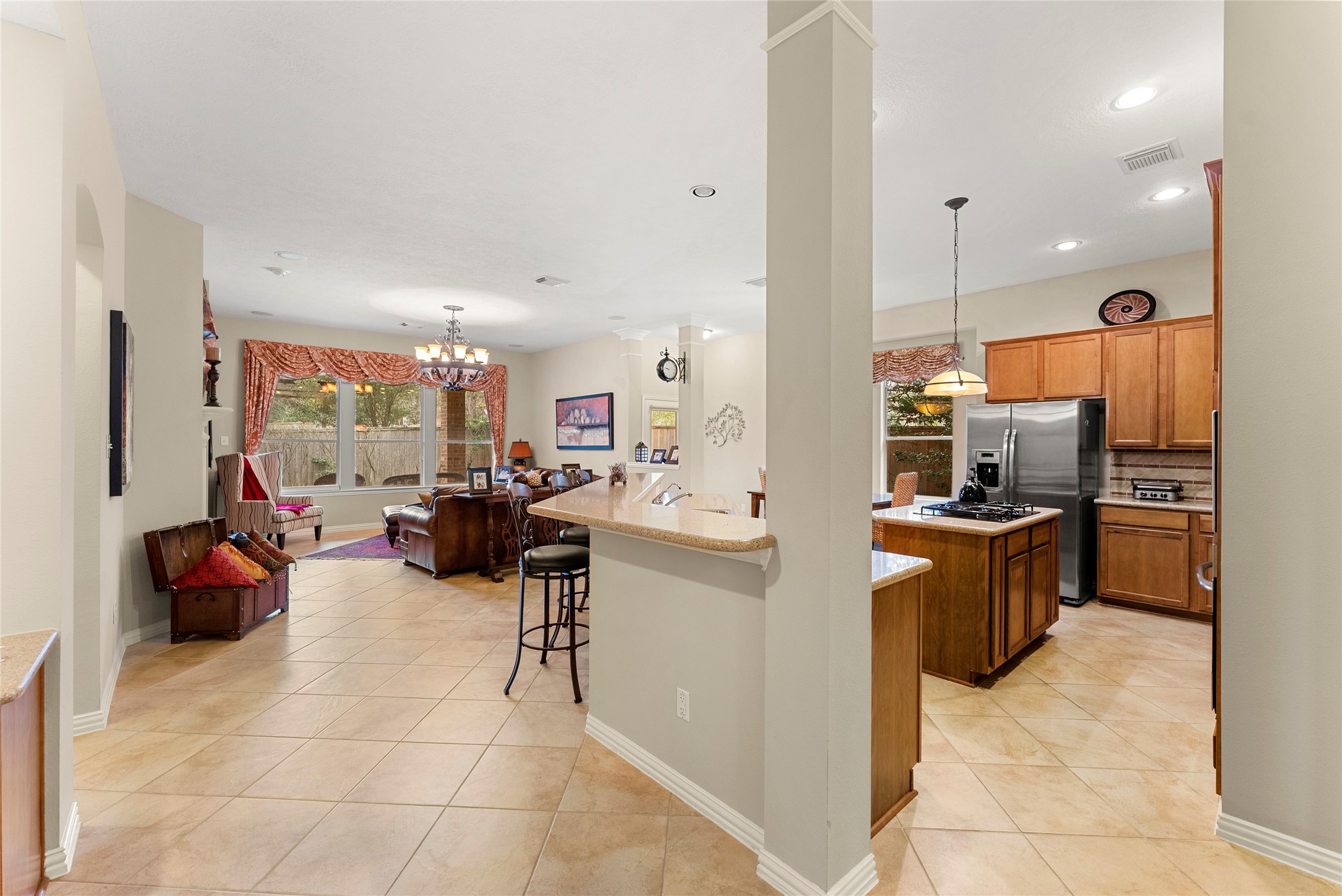 55 Granite Path Place Spring, TX 77389 - Photo 15 of 50 a kitchen with stainless steel appliances kitchen island granite countertop a sink and cabinets