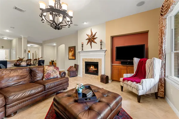 a living room with furniture or chandelier and a fireplace