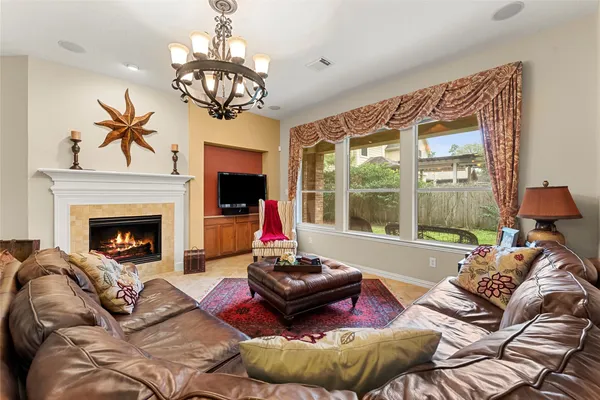 a living room with furniture fireplace and flat screen tv