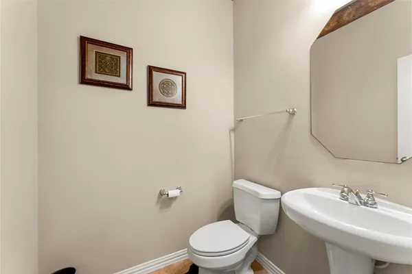 a white toilet sitting next to a white sink