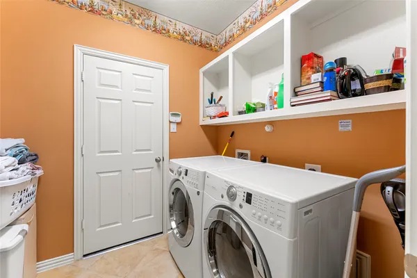 a view of a house with a yard and large trees