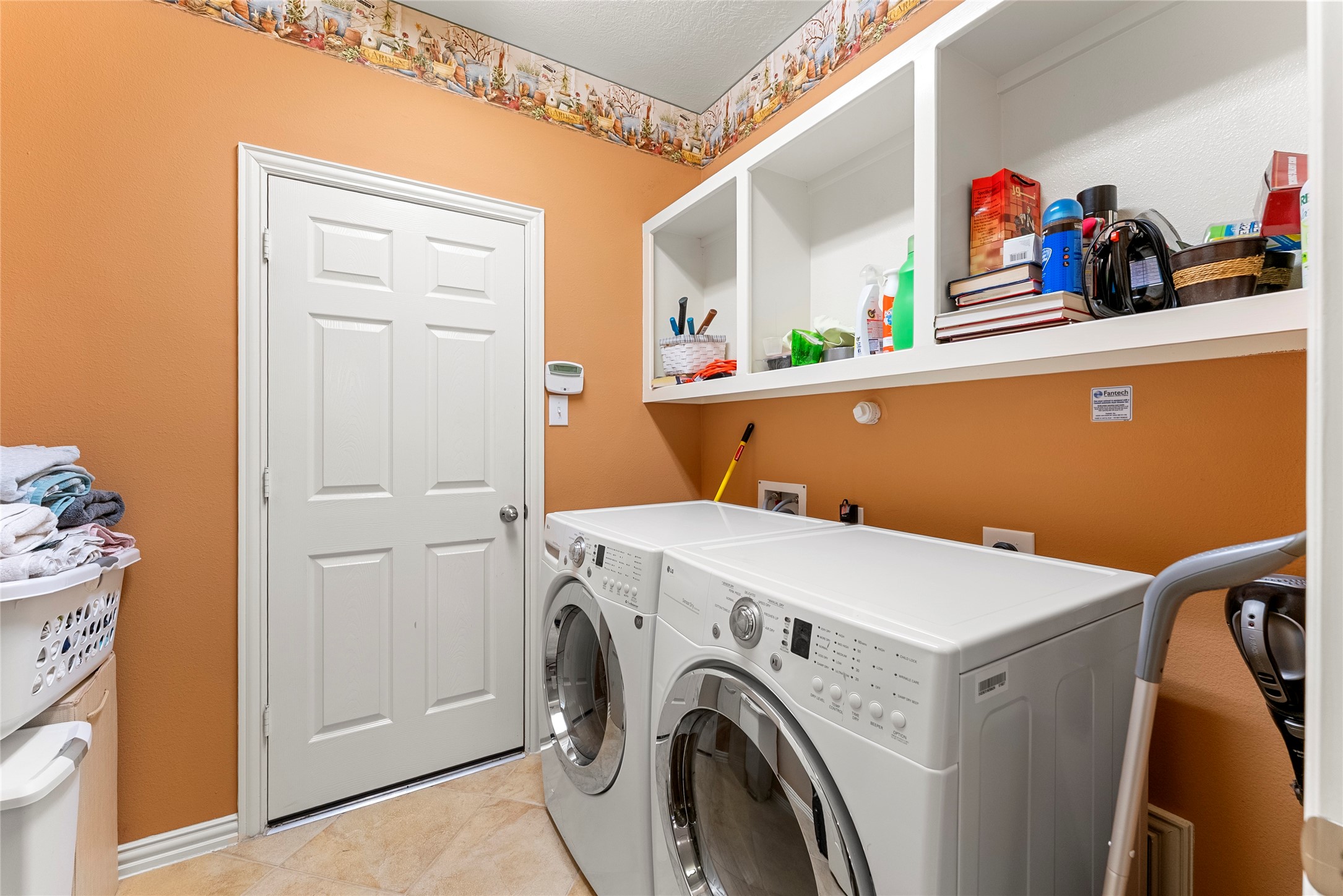 55 Granite Path Place Spring, TX 77389 - Photo 43 of 50 a view of washer and dryer with kitchen in the background