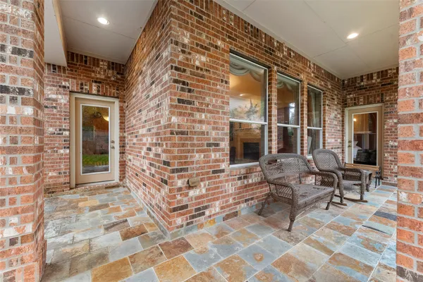 a view of a patio with a table chairs and a yard