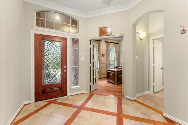 a view of a hallway with wooden floor and a living room