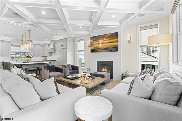 a living room with furniture large window and wooden floor