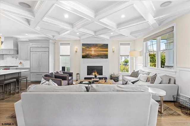 a kitchen with stainless steel appliances a sink a stove and white cabinets