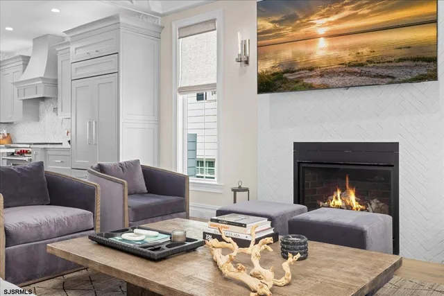 a dining room with furniture a chandelier and wooden floor