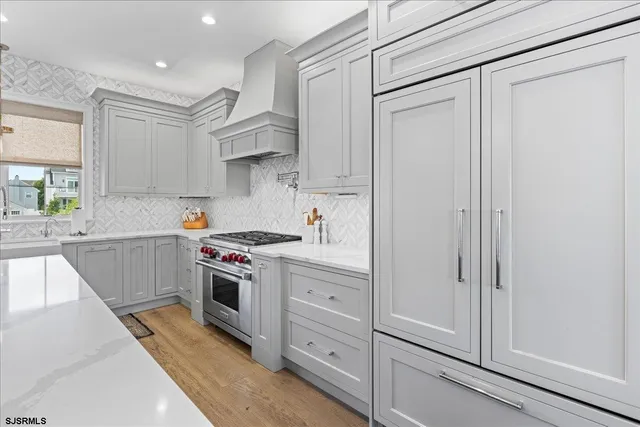 a spacious bathroom with double vanity a toilet a a mirror a vanity and shower