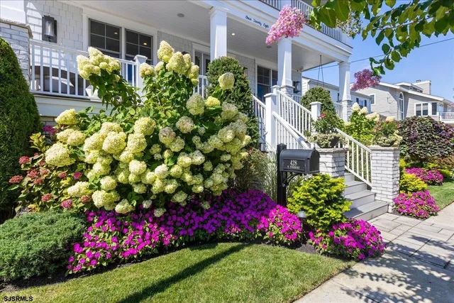 a living room with furniture fireplace and a large window